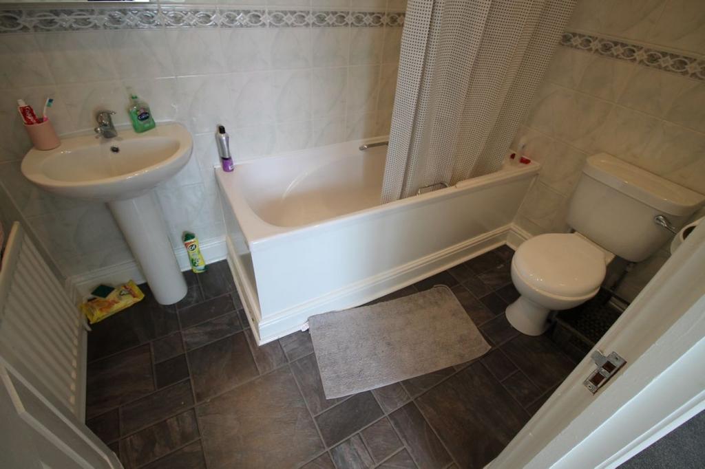 A well-maintained bathroom suite featuring a co...