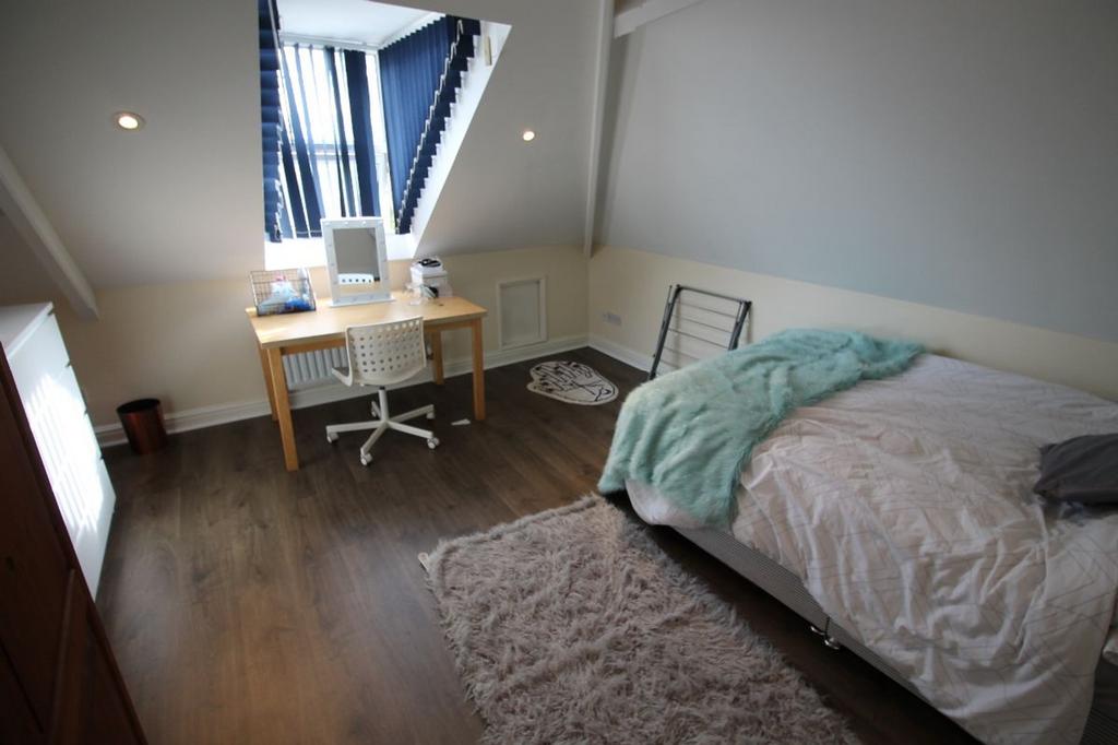 Spacious double bedroom featuring a cozy bed, a...