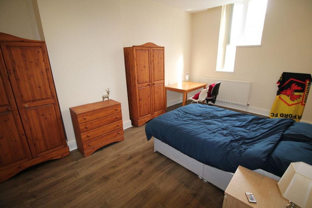 Spacious double bedroom featuring ample storage...