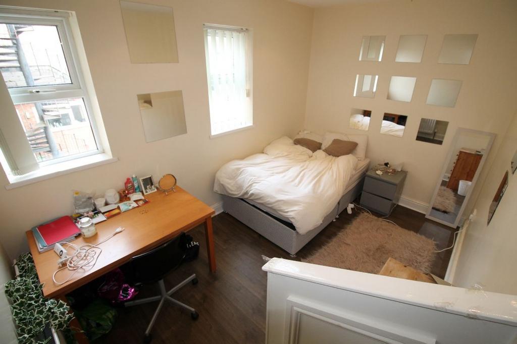 This inviting double bedroom features a cozy be...