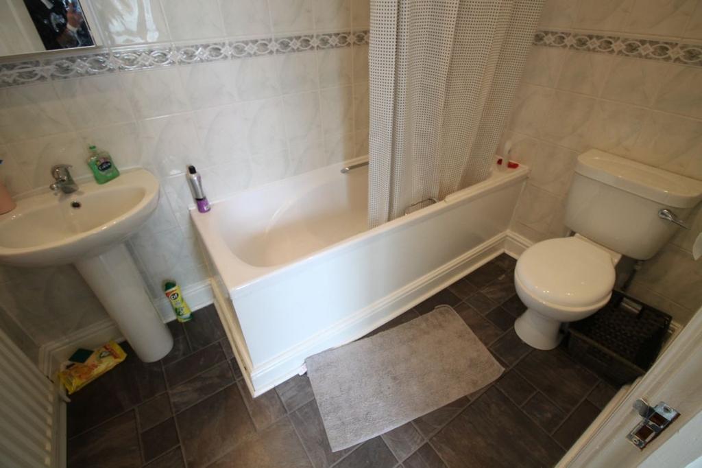This well-appointed bathroom suite features a s...