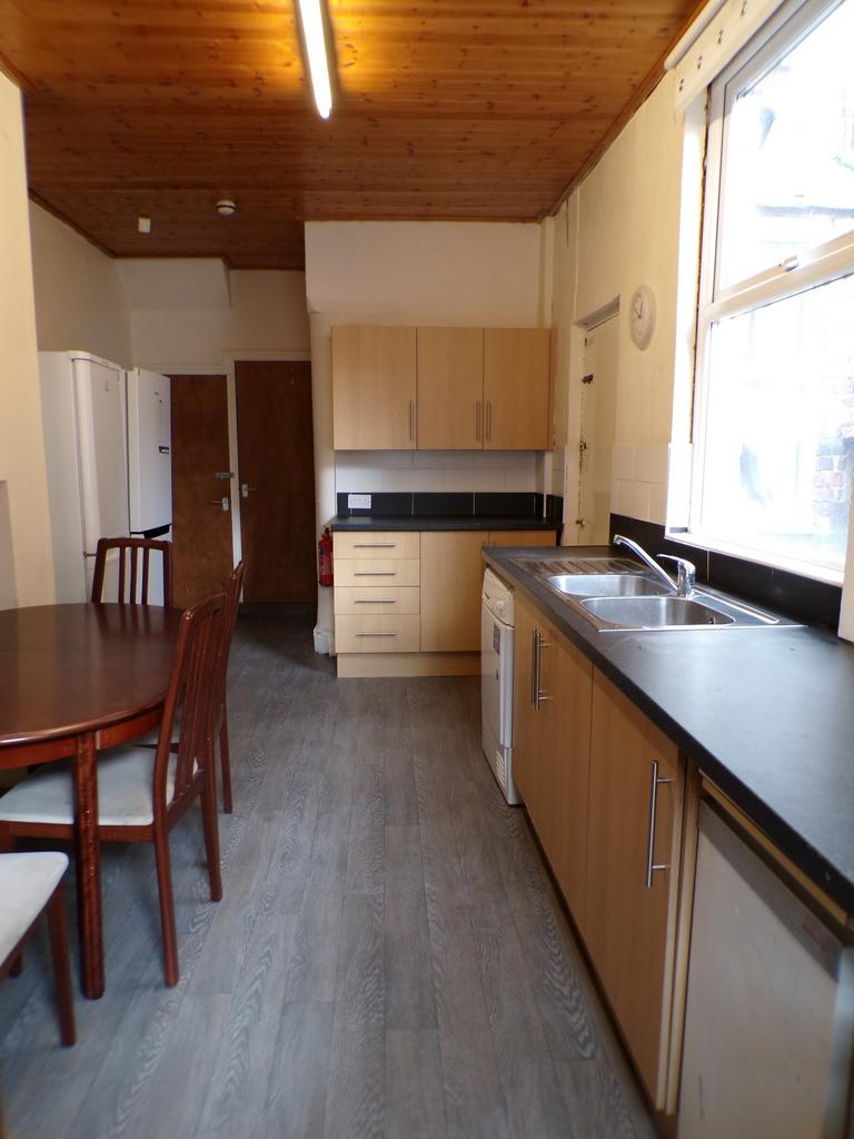 A spacious and bright kitchen area equipped wit...