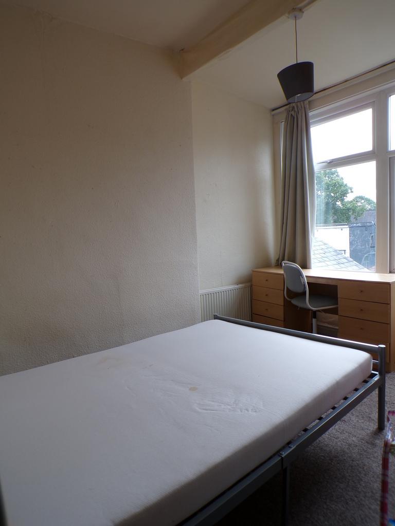 A bright and inviting double bedroom featuring ...