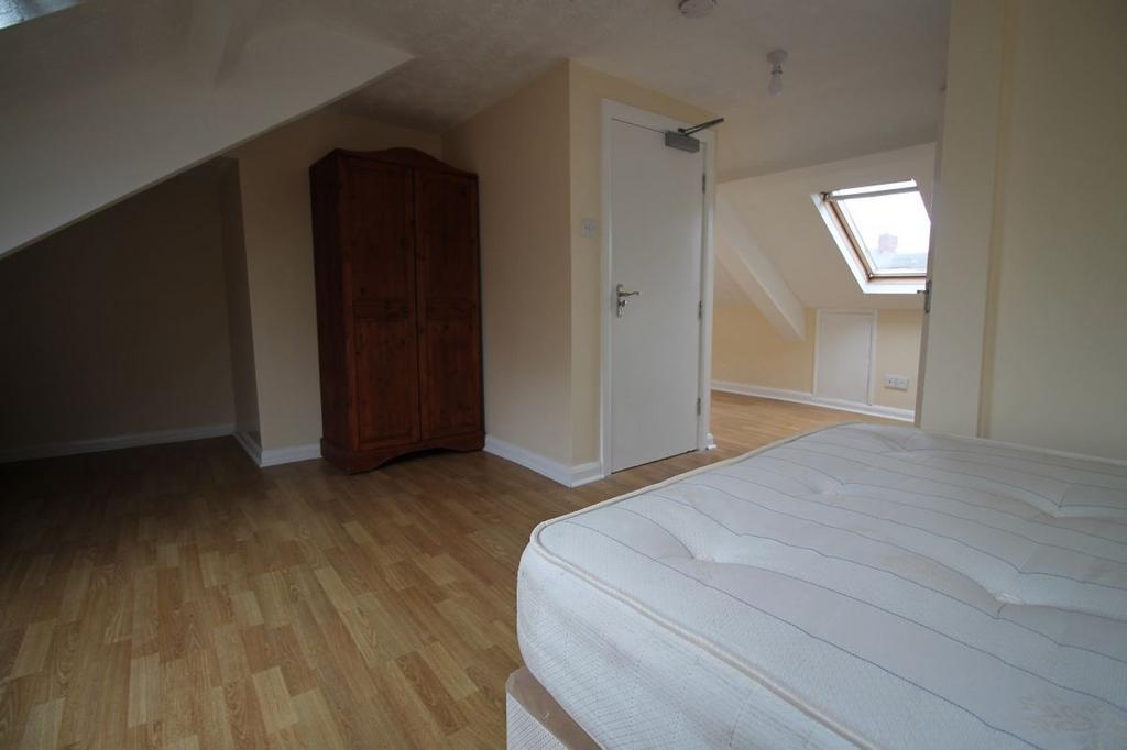 Spacious double bedroom featuring a cozy ambian...