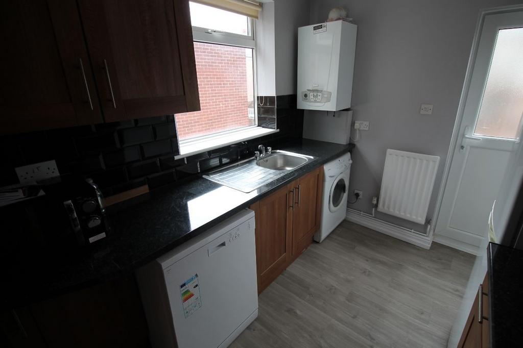 A well-equipped kitchen featuring modern applia...
