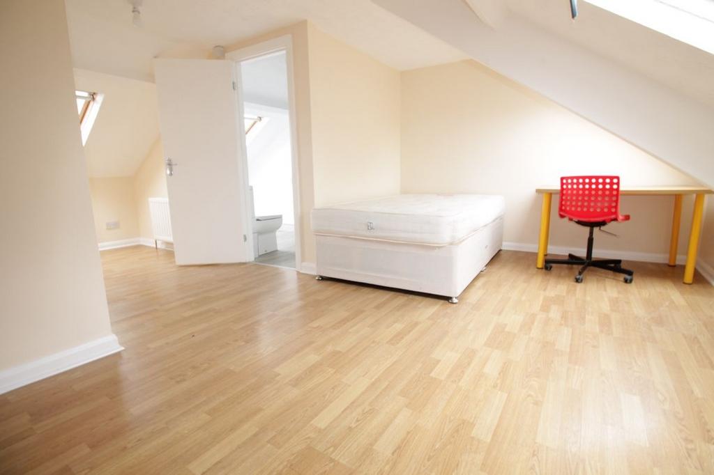 Spacious double bedroom featuring ample natural...