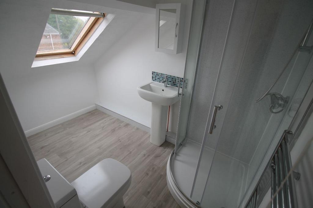 A modern bathroom featuring a sleek shower cubi...