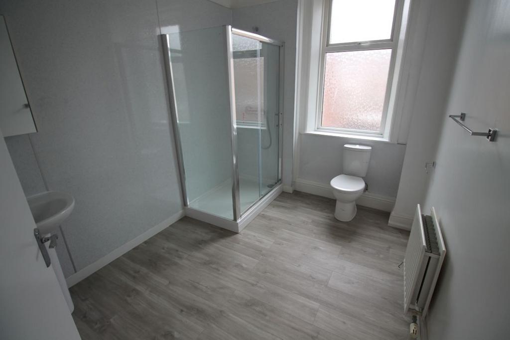 Bright and modern bathroom featuring a spacious...