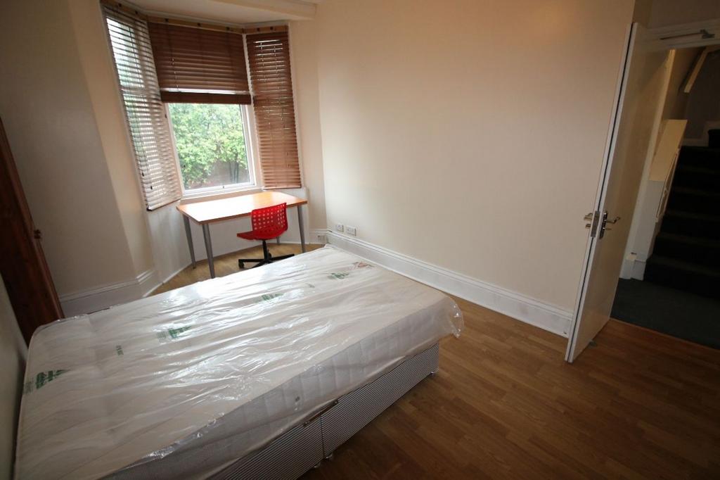 A bright and inviting double bedroom featuring ...