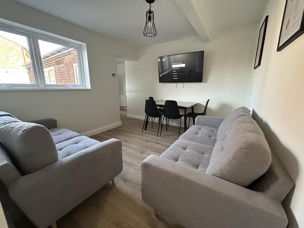 A spacious and inviting modern living room, per...
