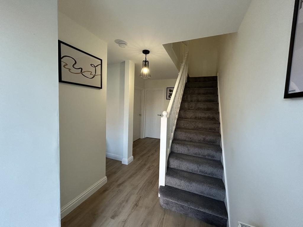 A bright and tidy hallway with modern decor, cr...