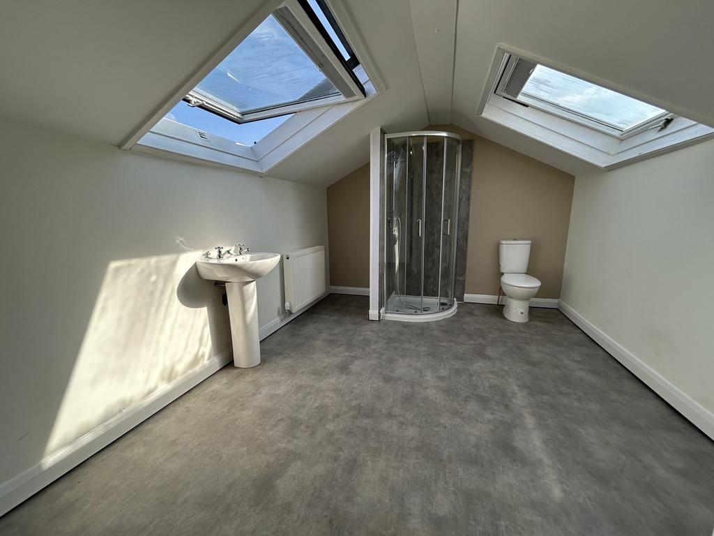 A spacious and bright bathroom featuring modern...