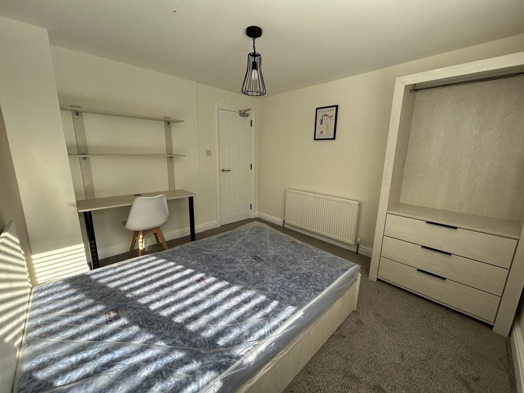 A bright and spacious double bedroom featuring ...