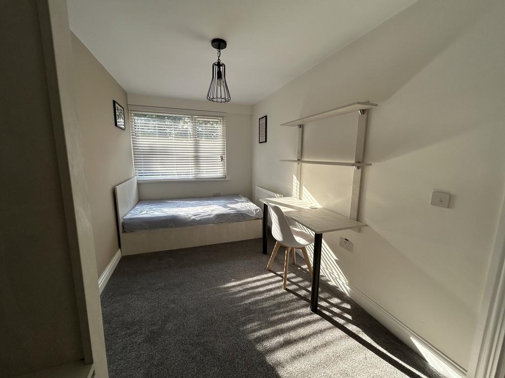 A bright and inviting double bedroom featuring ...