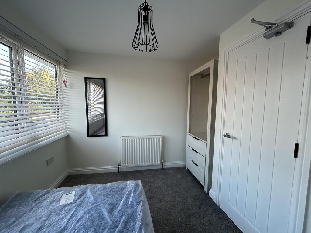 A bright and stylish double bedroom featuring m...