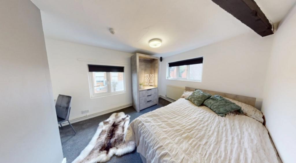 A bright and inviting double bedroom featuring ...