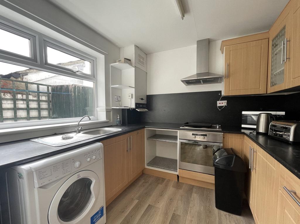 A bright and modern kitchen featuring ample sto...