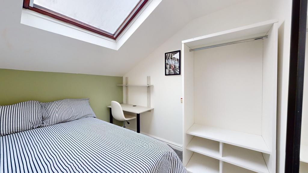 A bright and inviting double bedroom featuring ...