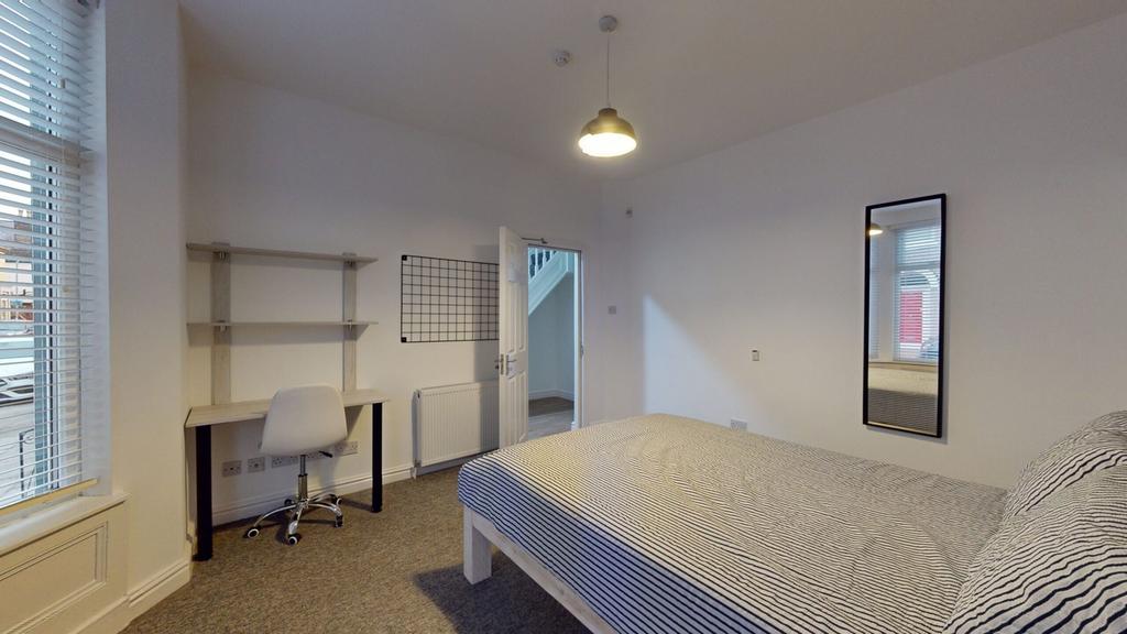 A bright and spacious double bedroom featuring ...