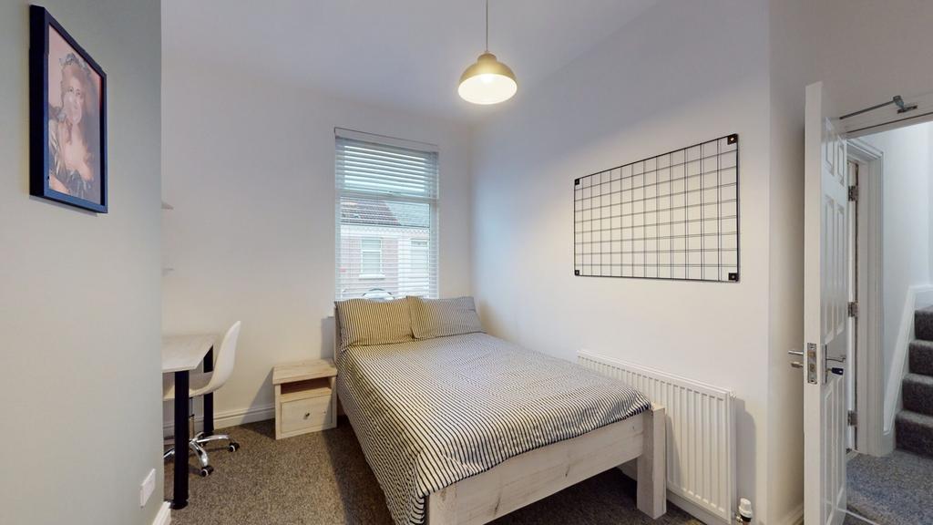 A bright and tidy double bedroom with a comfort...