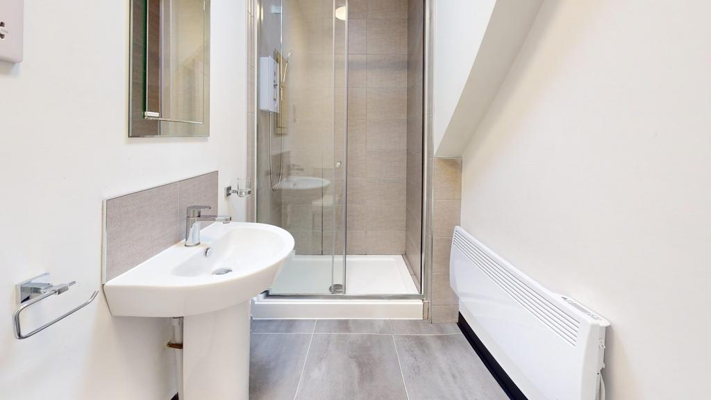 A modern and tidy bathroom featuring a sleek sh...