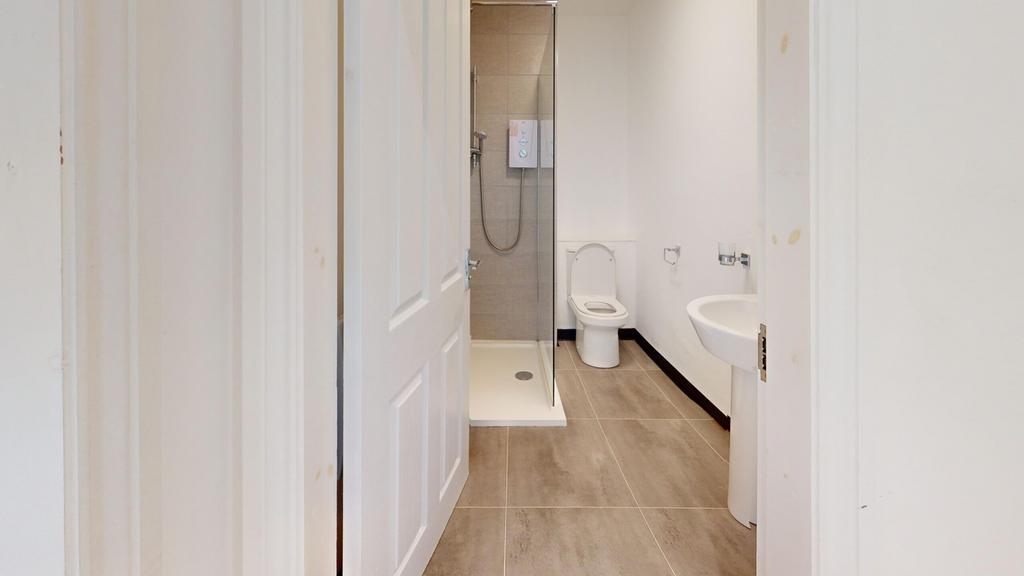 A modern and tidy bathroom featuring a shower, ...