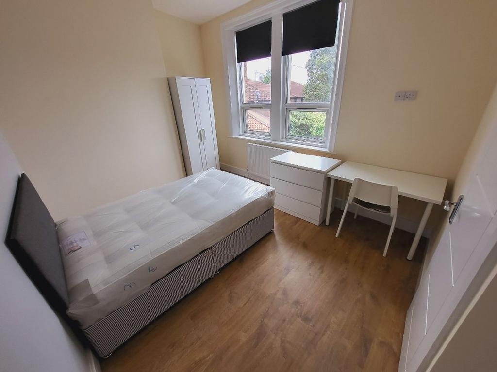 Bright and spacious double bedroom featuring a ...