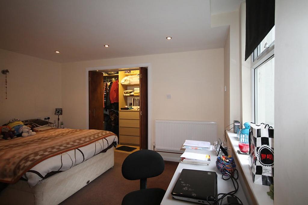 Cozy double bedroom featuring ample natural lig...