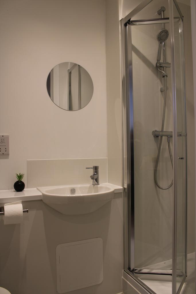 A modern and tidy bathroom featuring a sleek sh...