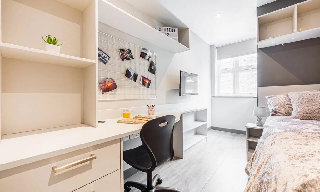 A bright and spacious double bedroom with a mod...