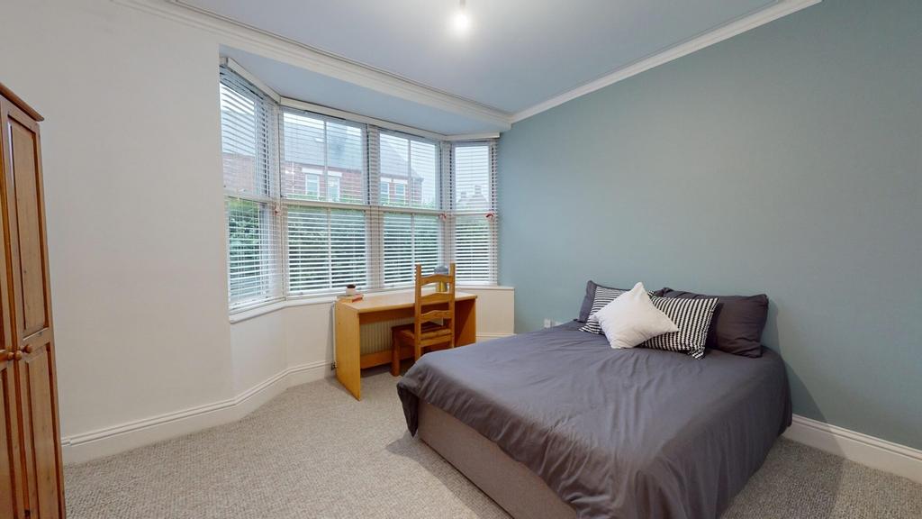 A spacious and well-lit double bedroom featurin...
