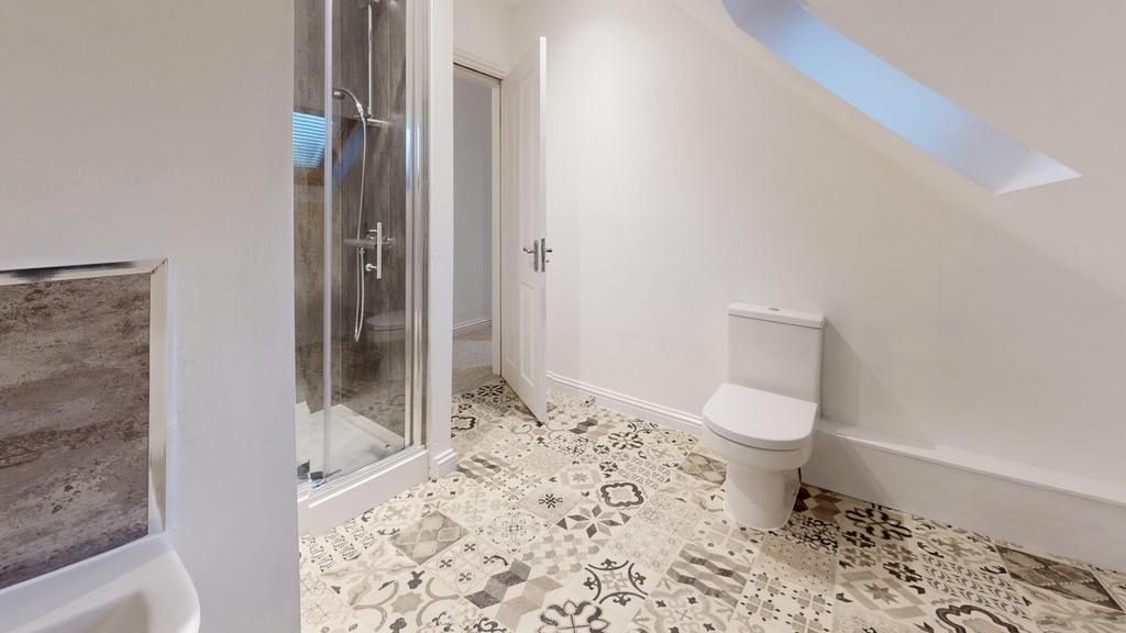 A stylish and modern bathroom featuring a spaci...