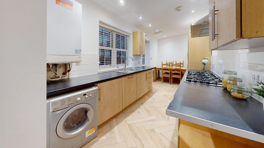 A spacious and modern kitchen featuring ample s...