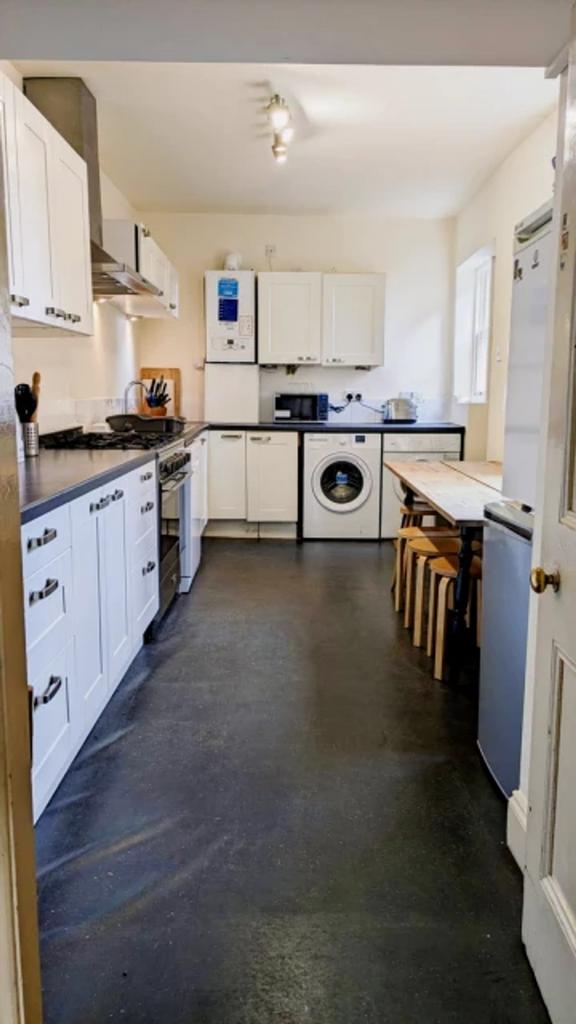 A spacious and bright kitchen featuring modern ...
