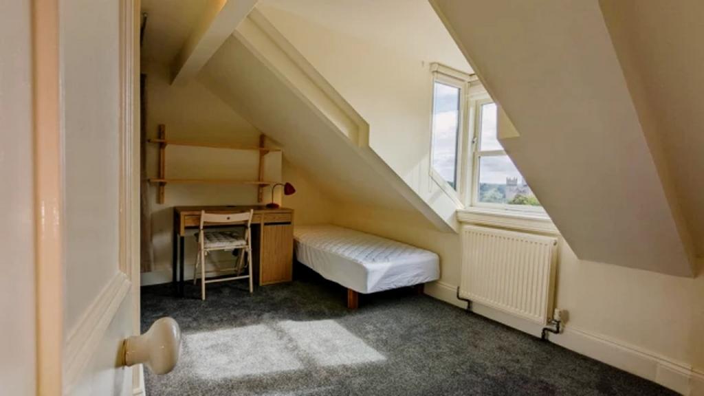A bright and tidy double bedroom with a cozy st...