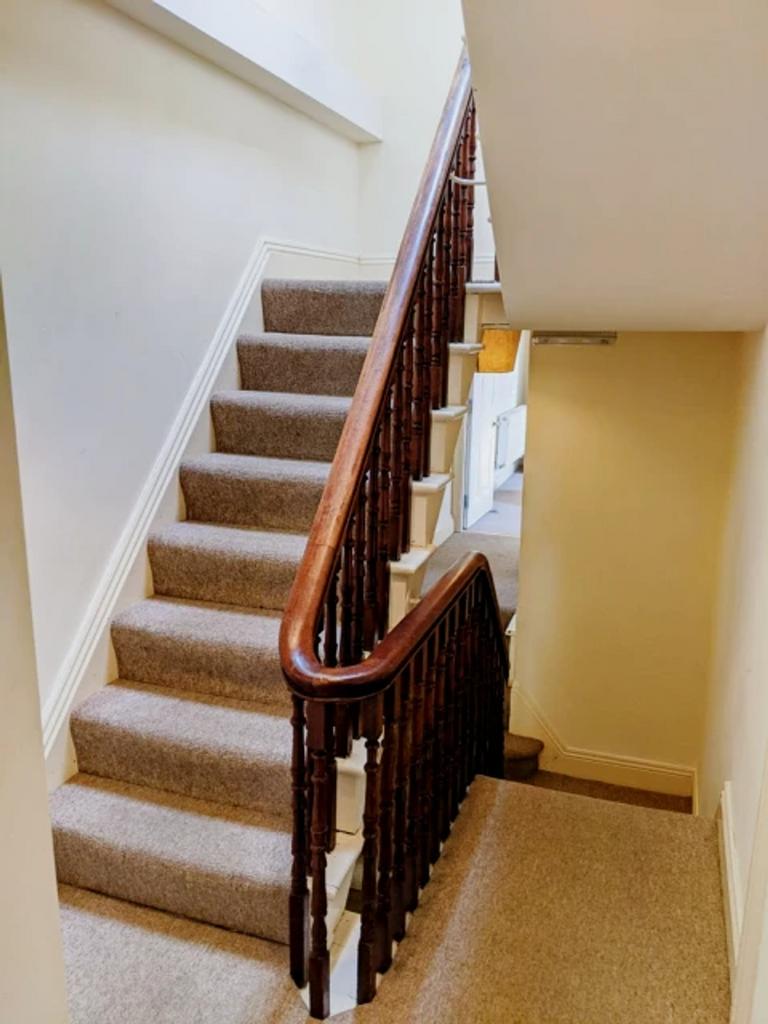 A well-maintained staircase with elegant wooden...