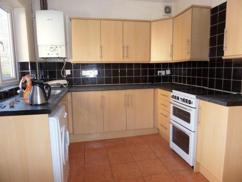 A bright and functional kitchen with modern cab...