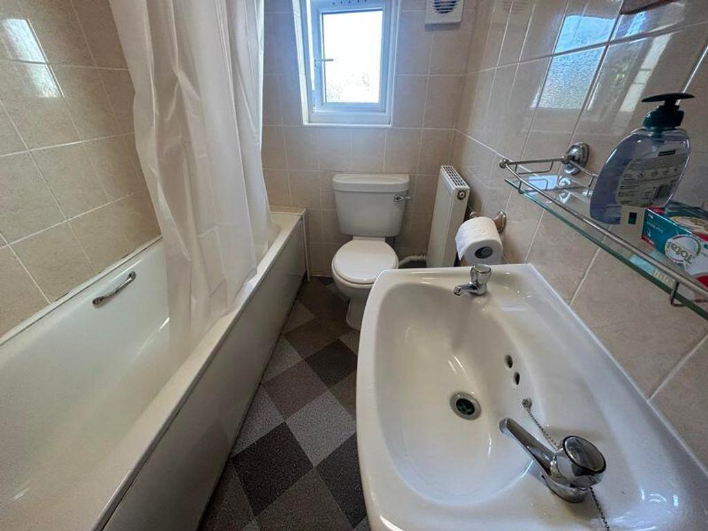A clean and well-maintained bathroom featuring ...