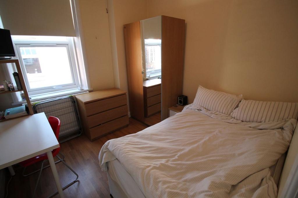 Cozy double bedroom featuring ample natural lig...
