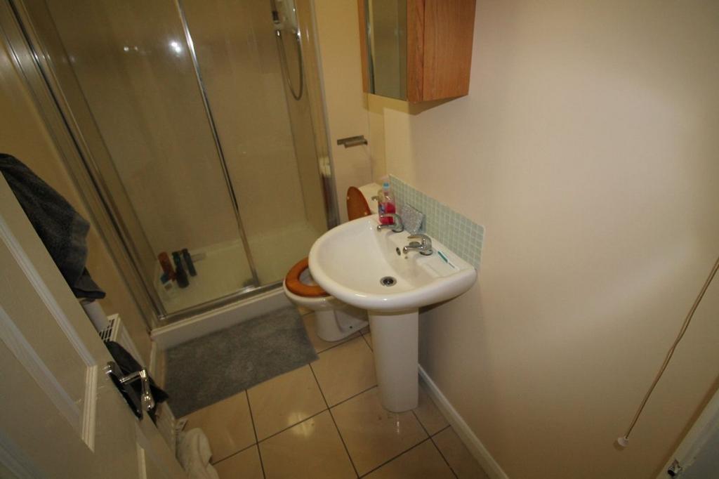 This well-maintained bathroom features a modern...