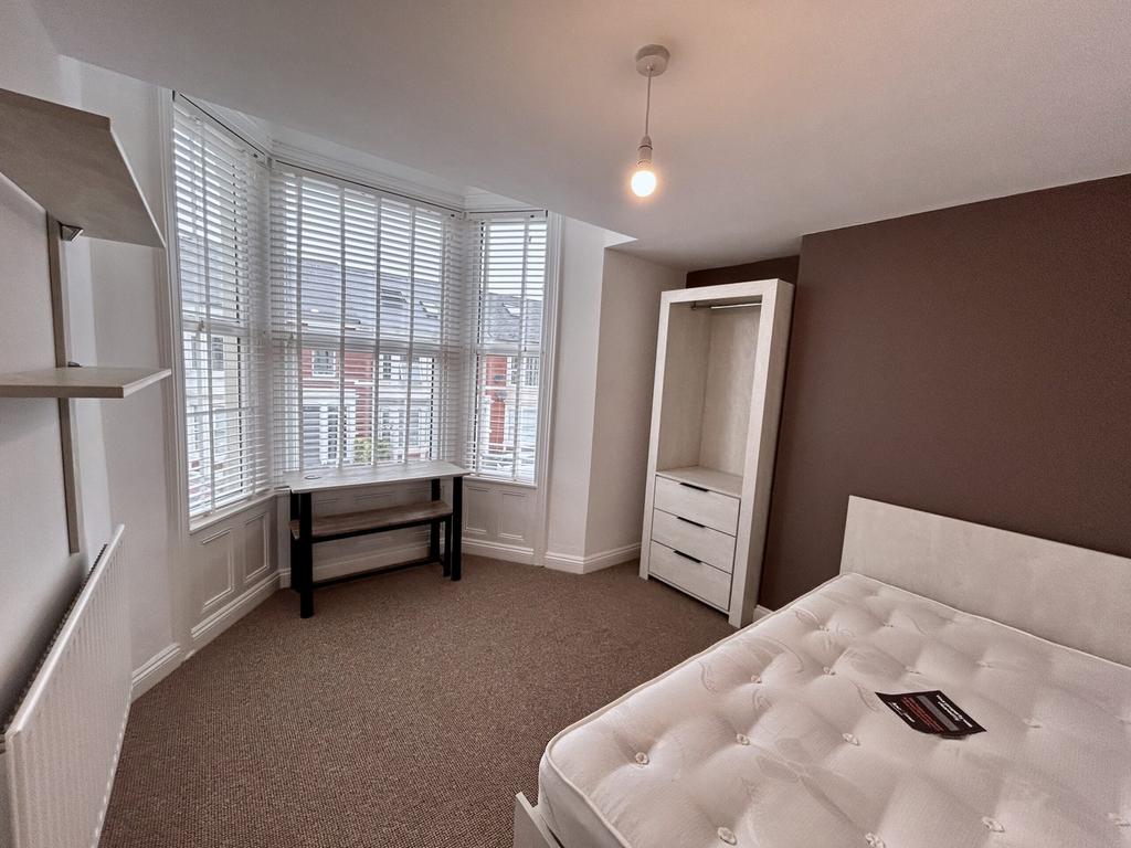 A bright and spacious double bedroom featuring ...