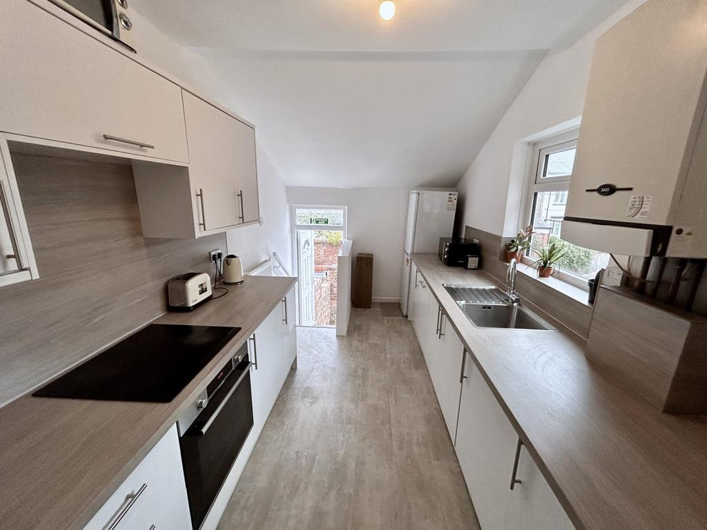 A modern and spacious kitchenette with ample na...