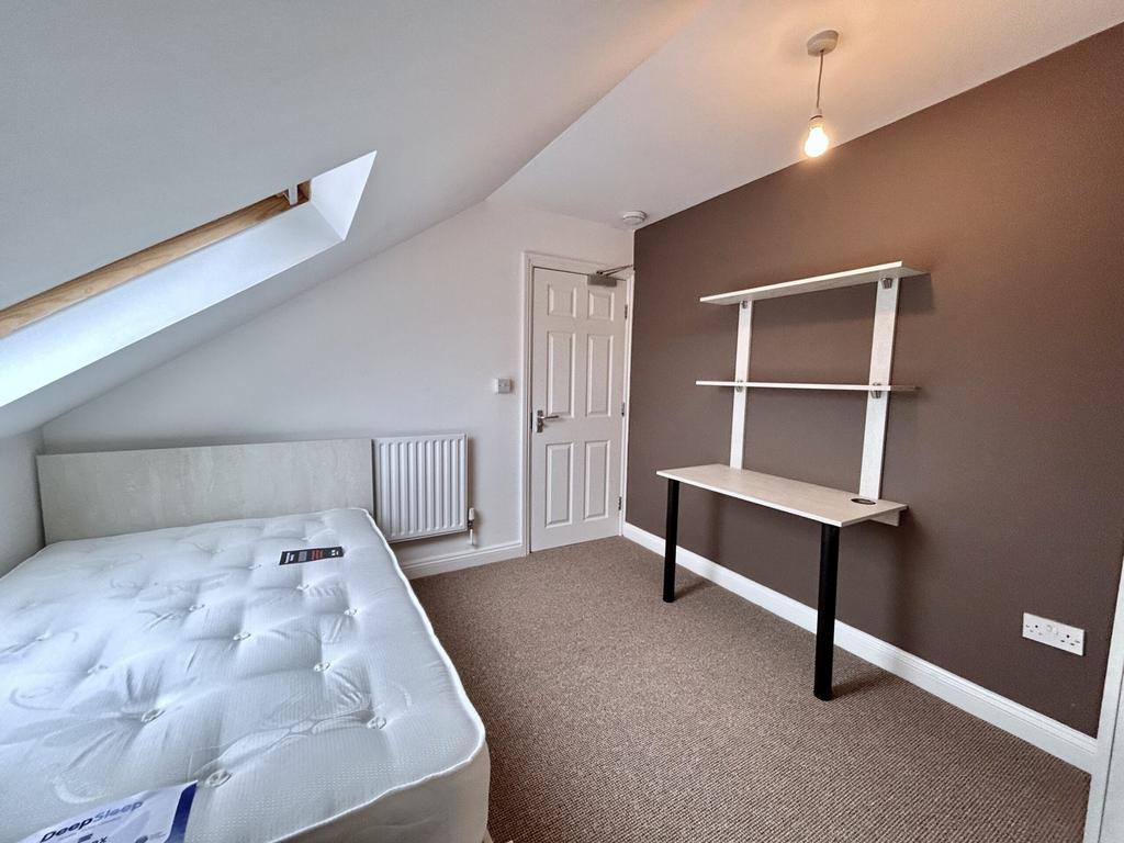 A bright and inviting double bedroom featuring ...