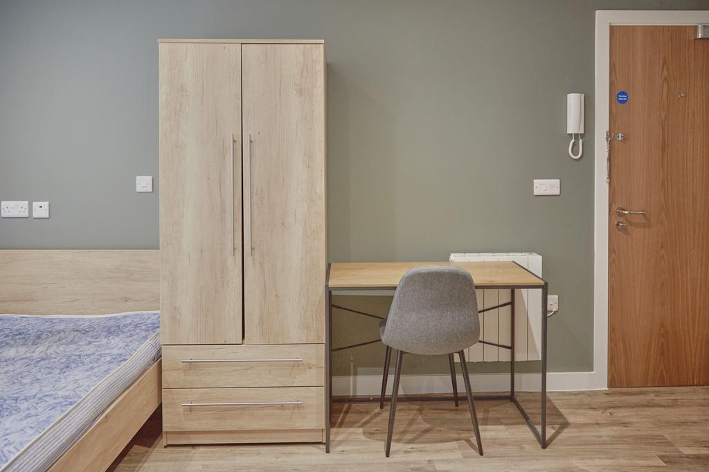 A modern and tidy double bedroom featuring a fi...