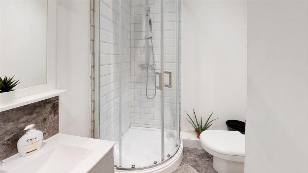 A modern and pristine bathroom featuring a styl...