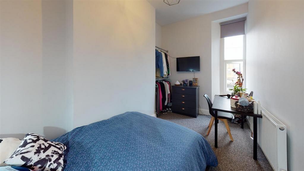A cozy and inviting double bedroom with ample s...