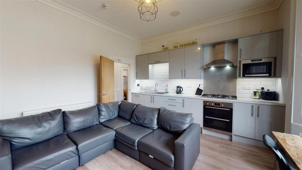 A modern and inviting kitchenette with ample sp...
