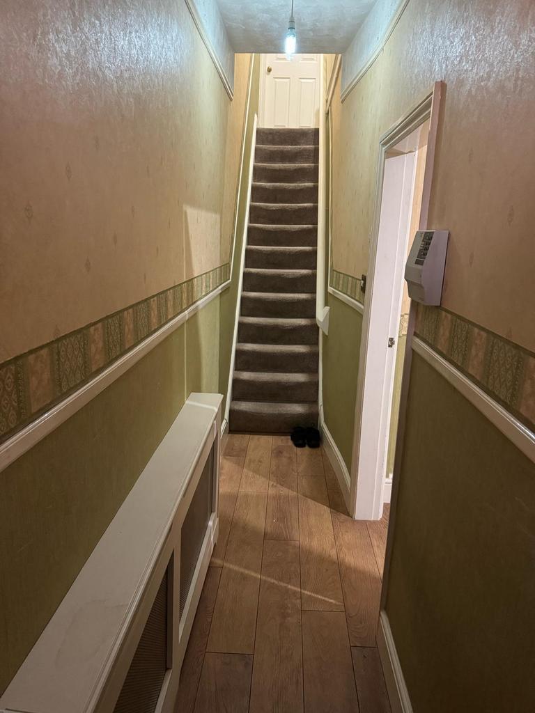 This inviting hallway features warm colors and ...
