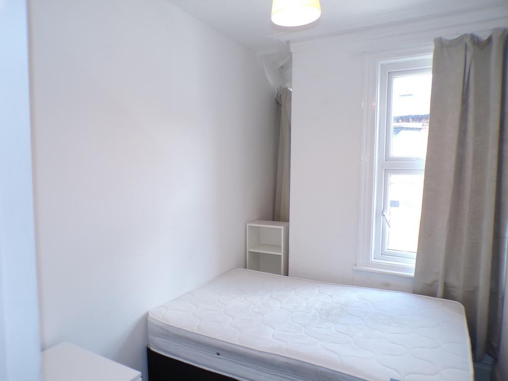 A bright and tidy double bedroom featuring natu...