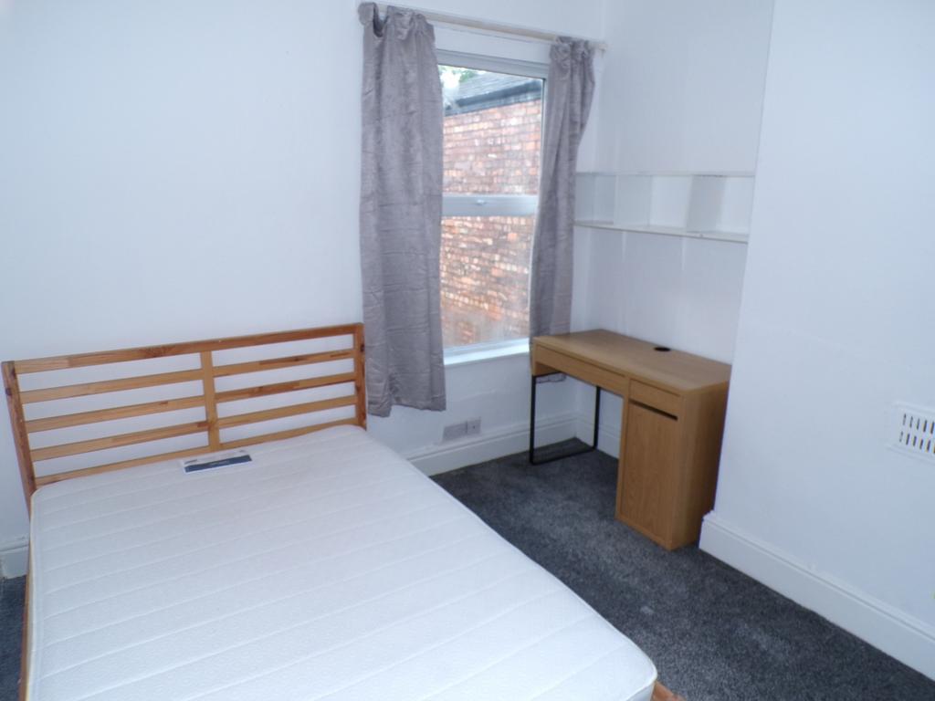 A bright and tidy double bedroom featuring a co...